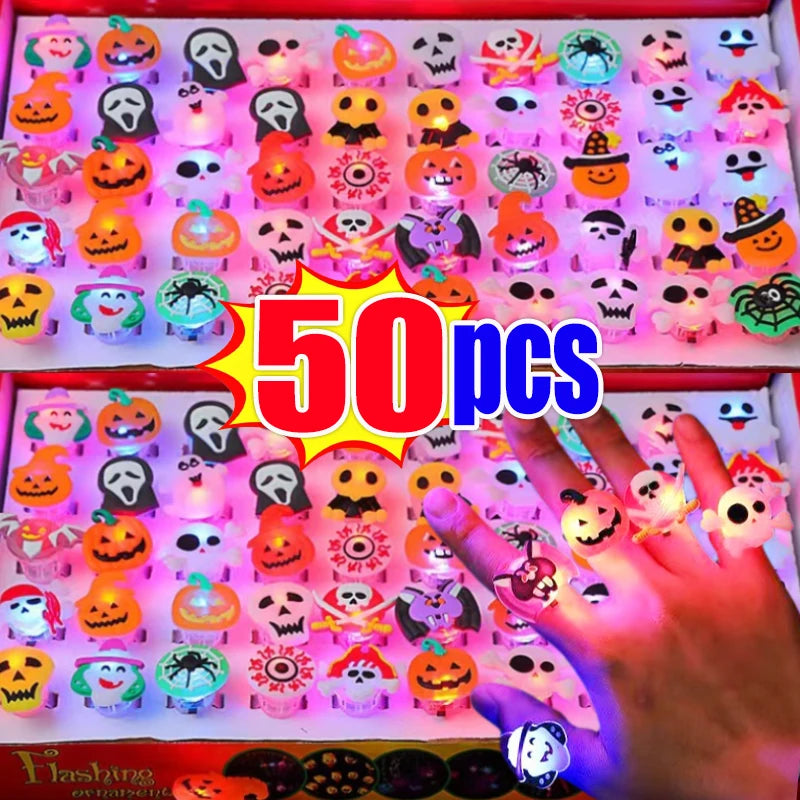 A close-up of 50 glow rings in various Halloween themes, including pumpkins, skulls, and spooky faces, displayed in a red box