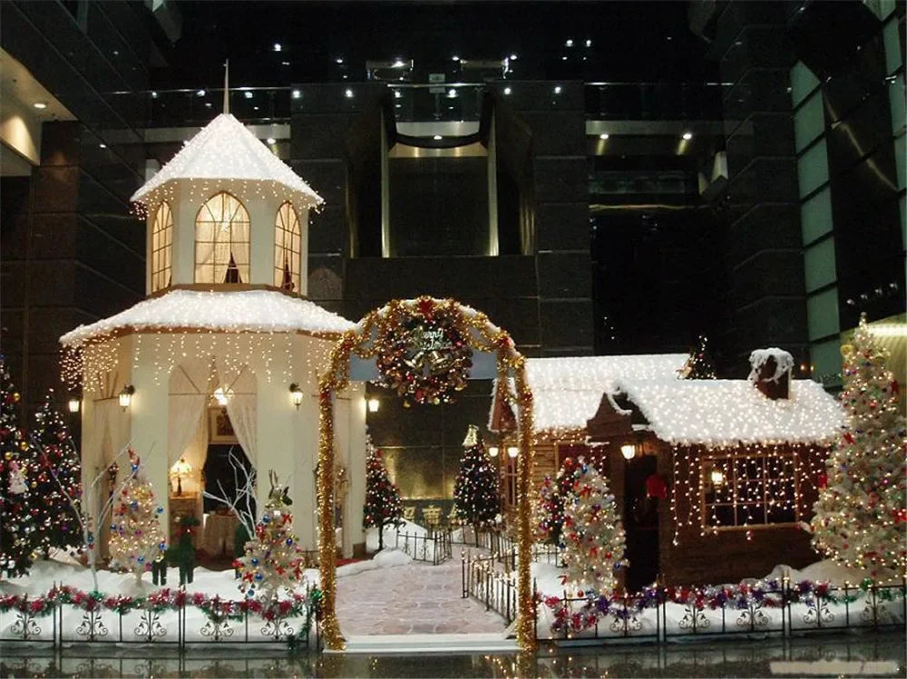 A display featuring a white plush Christmas tree skirt with snowflake designs surrounded by decorated miniature buildings and