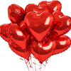 A bunch of shiny red heart-shaped foil balloons tied together for a celebration