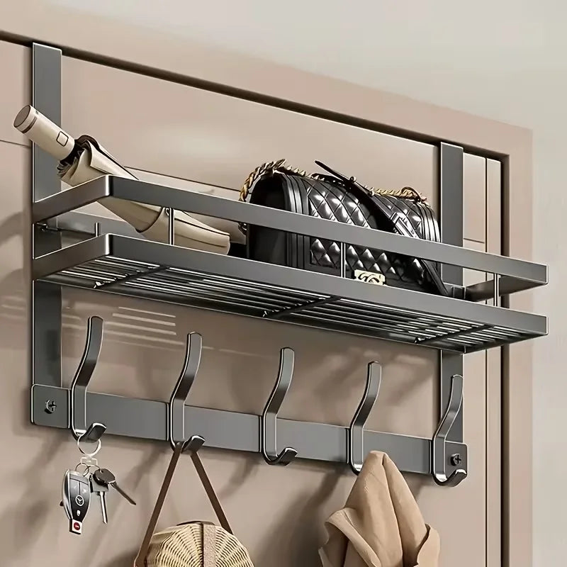 A metal over-the-door organizer rack with multiple shelves and hooks mounted on a wall.