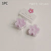 A single pink scented tea light candle in a clear plastic wrapper is shown on a white background.