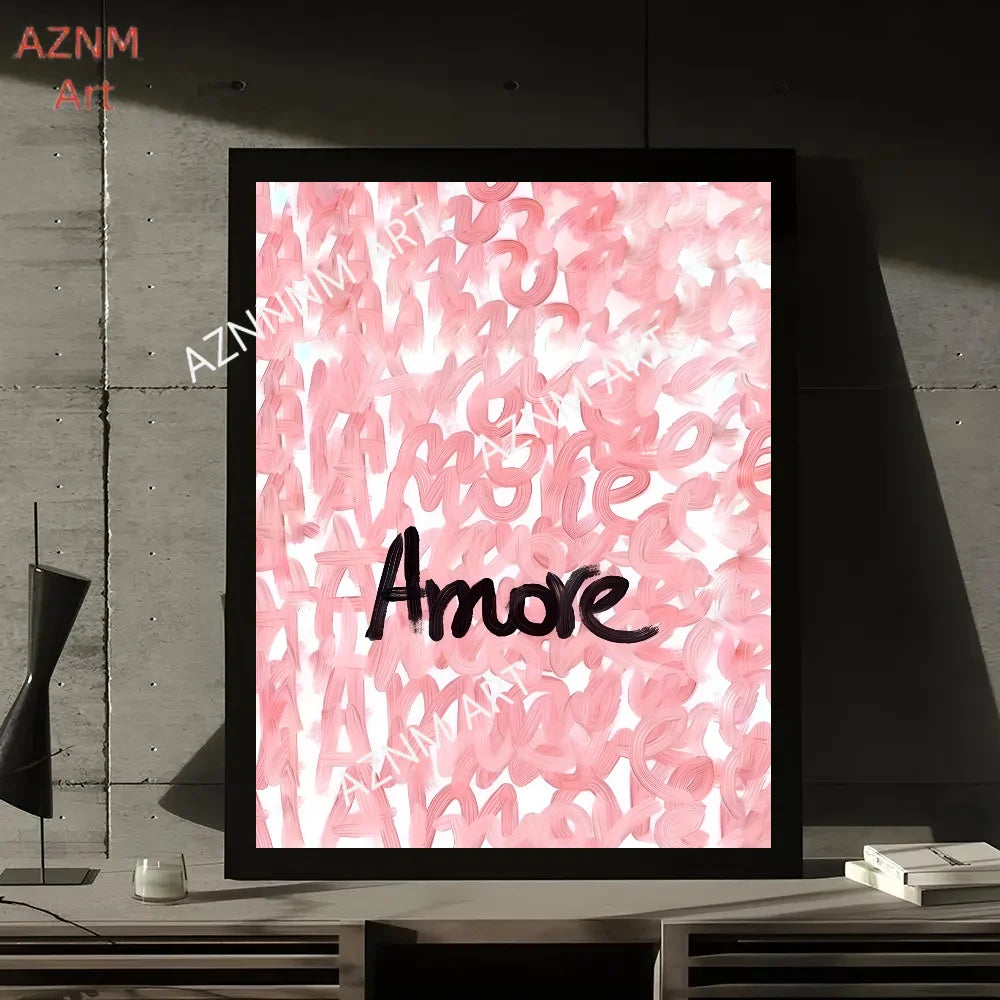 A framed print featuring abstract pink script text that reads Amore on a white background.