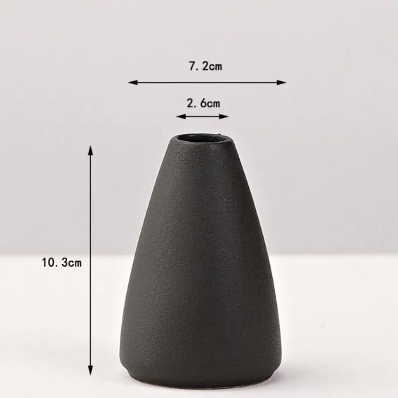 A matte black ceramic vase with a conical shape, shown against a white background.