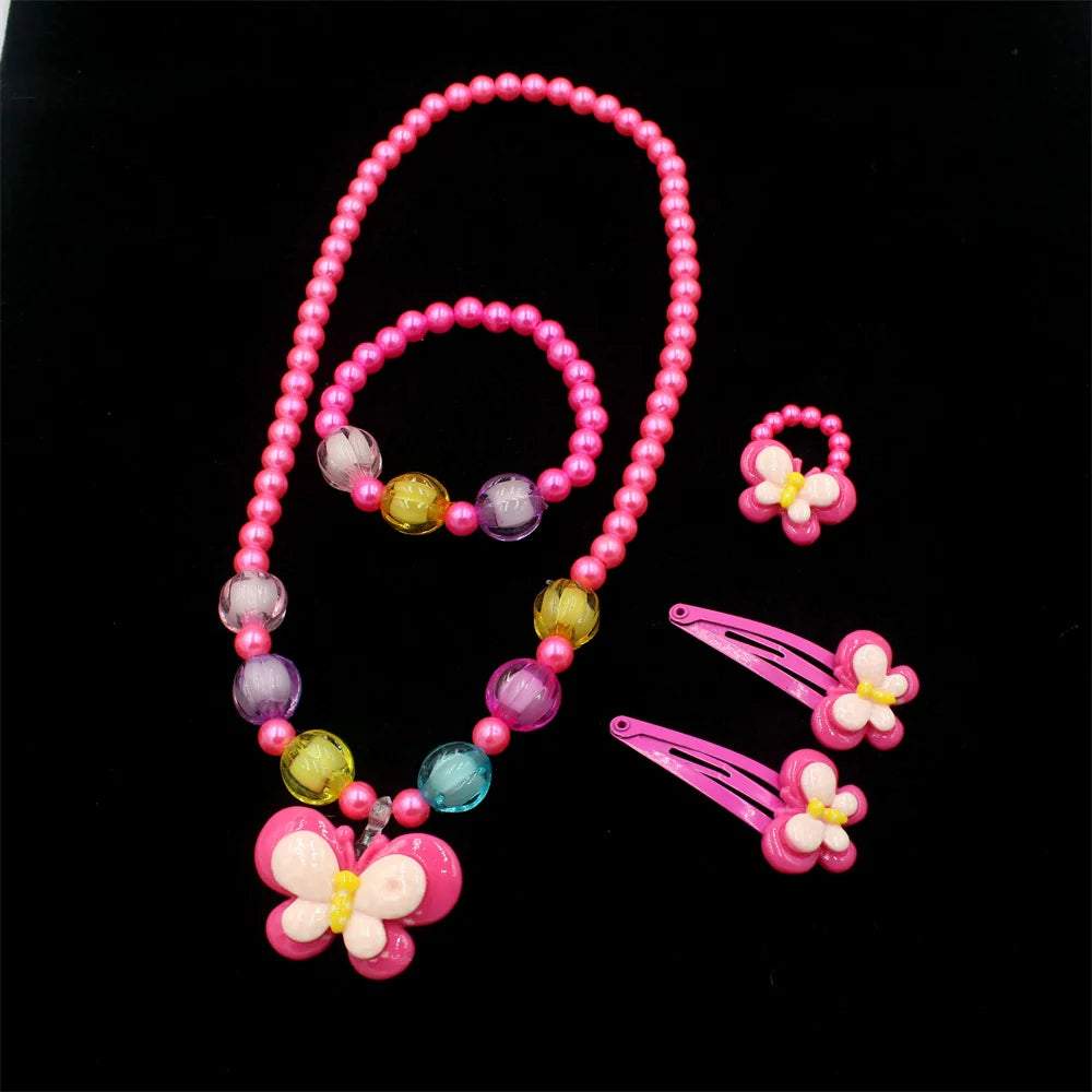 A set of pink and purple beaded jewelry including a necklace and butterfly hair clips.