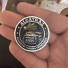 A hand holds an Alcatraz themed coin featuring an alligator design and the text Inmate #2025 Florida Everglades.