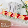 A clear acrylic rectangular vase filled with various colorful roses and other flowers.