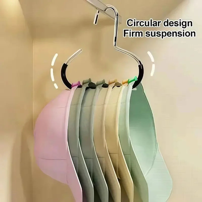 A set of five circular design firm suspension hooks for organizing baseball caps mounted on a wall.