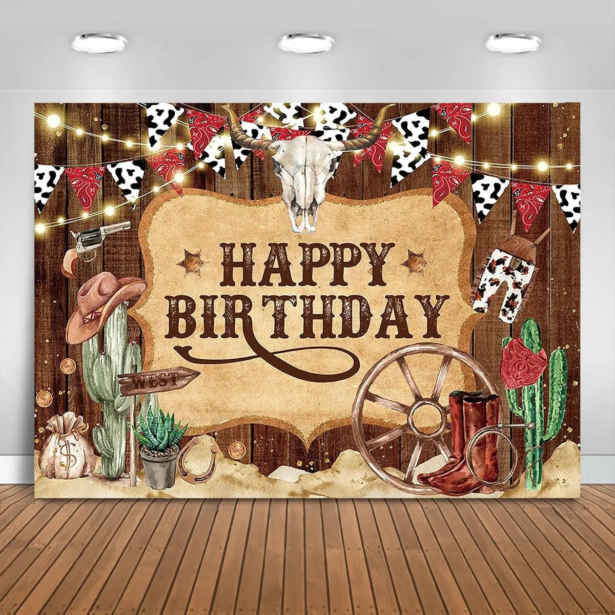 A rustic western backdrop featuring a skull, cacti, and decorative string lights for a birthday theme.