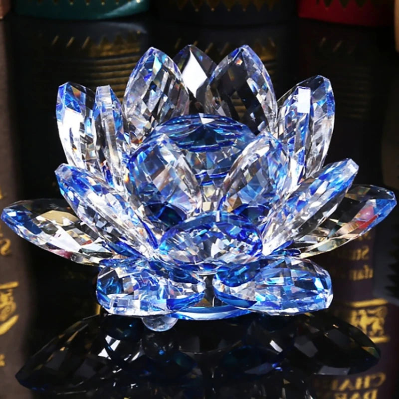 A brilliant blue crystal lotus flower ornament resting on a dark reflective surface.