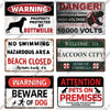 A collection of vintage warning metal signs featuring text like WARNING DANGER and ATTENTION PETS ON PREMISES