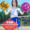 A young woman holds a bright yellow pom pom in one hand and a vibrant purple pom pom in the other.