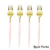 Eight pieces of gold and pink disposable forks for party tableware