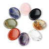 A collection of oval natural stone beads in various colors including blue, pink, black, green, orange, and purple arranged in