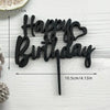 Black acrylic birthday cake topper set with the words Happy Birthday in a script font