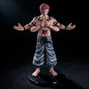 A figurine of a male anime character with pink hair and a fierce expression, wearing traditional clothing.