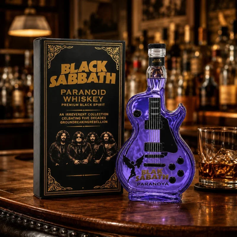 A bottle of Black Sabbath premium whiskey in a guitar-shaped glass decanter sits on a wooden bar top.