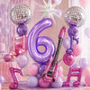 Purple music theme birthday party decorations featuring balloons and musical instrument props