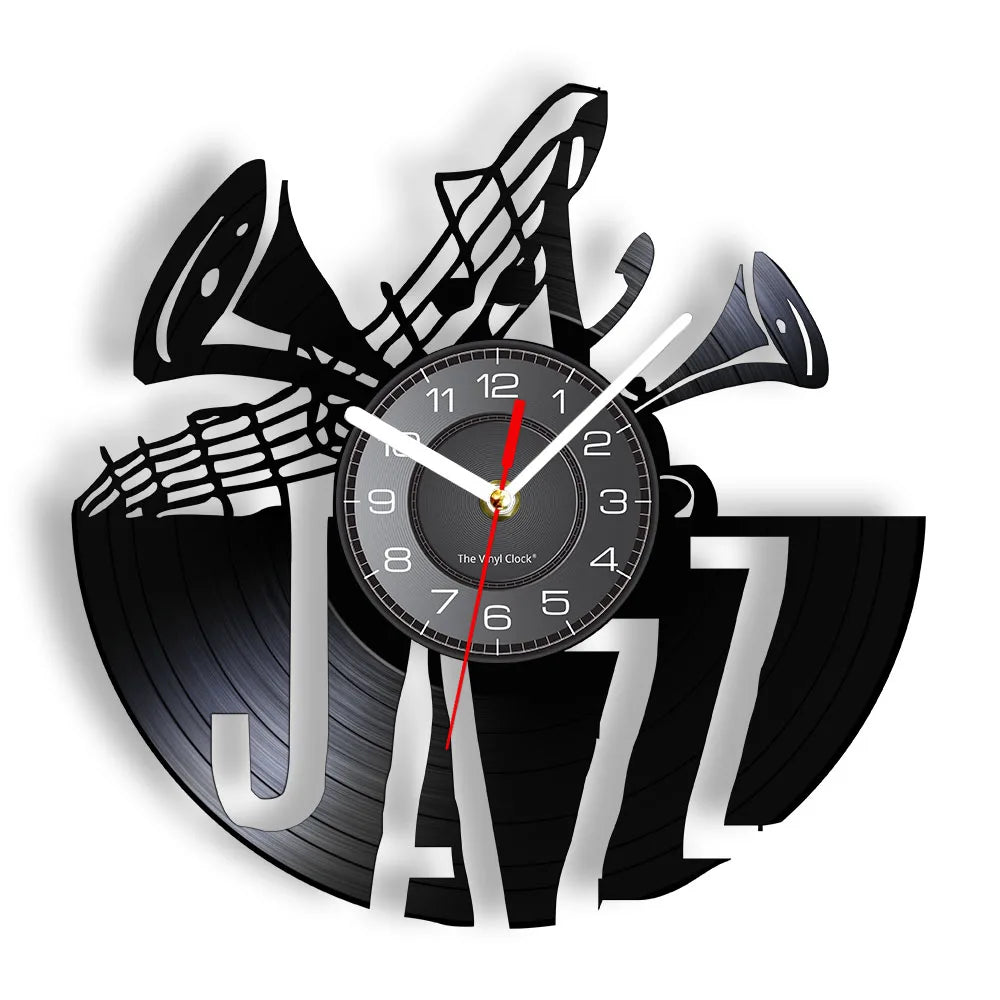 A black wall clock shaped like the letter J with a vinyl record design and a clock face.