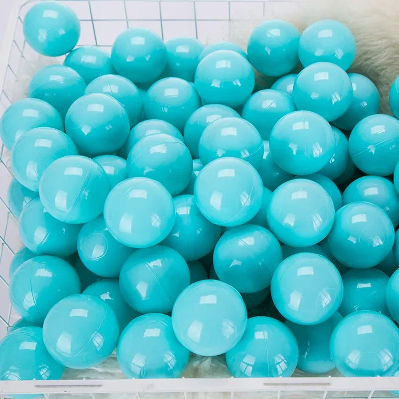 A large quantity of light blue and turquoise plastic balls are displayed in a clear container.