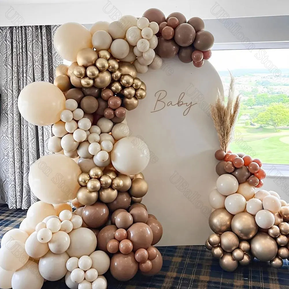 A large arrangement of brown and cream latex balloons for a baby shower or birthday decoration.