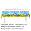 Colorful fabric tablecloth featuring cartoon characters and rainbows for a birthday party