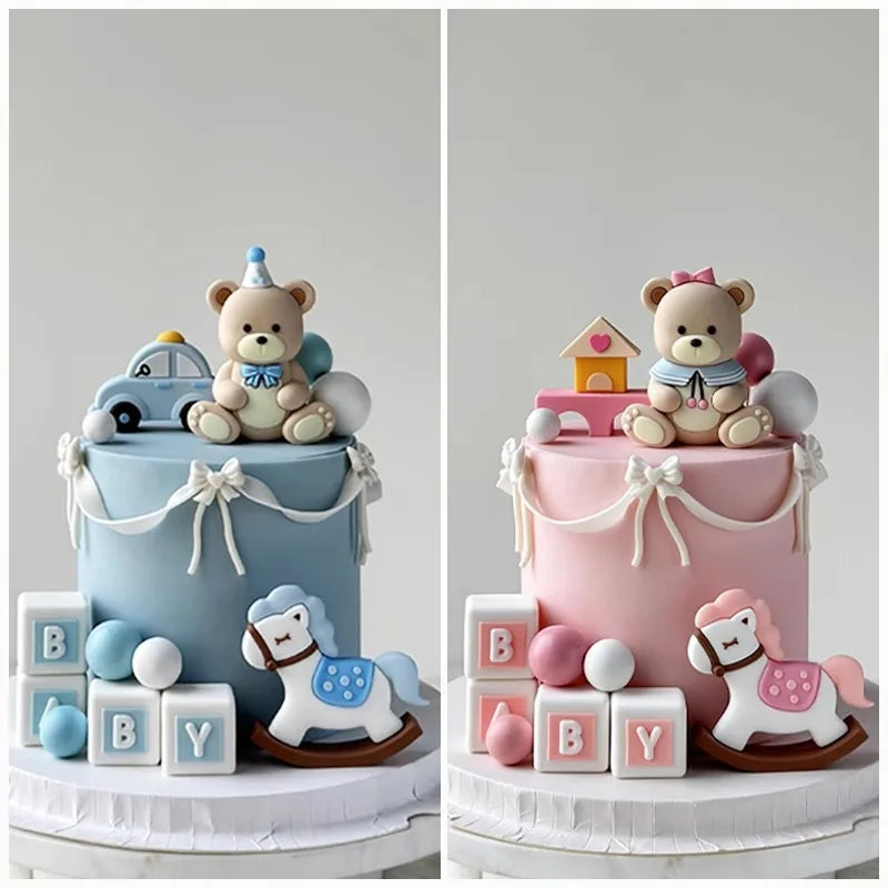 Two tiered cake display featuring bear and car themed toppers and baby blocks