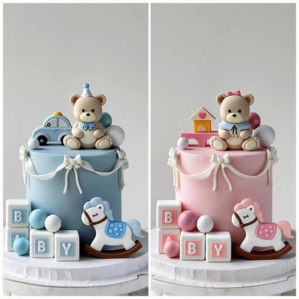 Two tiered cake display featuring bear and car themed toppers and baby blocks