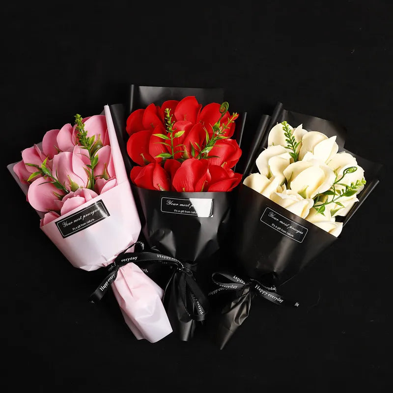 A bouquet of handcrafted soap roses in pink and red are presented in black paper packaging.