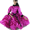 A handmade doll dress gown in vibrant pink satin with black accents and a black hair accessory.