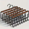 A wall-mounted metal coat rack with eight hooks and a storage box, featuring wooden bars.