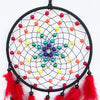 A black mesh dream catcher with colorful beads and red feathers hanging from it.