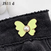 Gold pearl butterfly buttons attached to a black denim fabric.