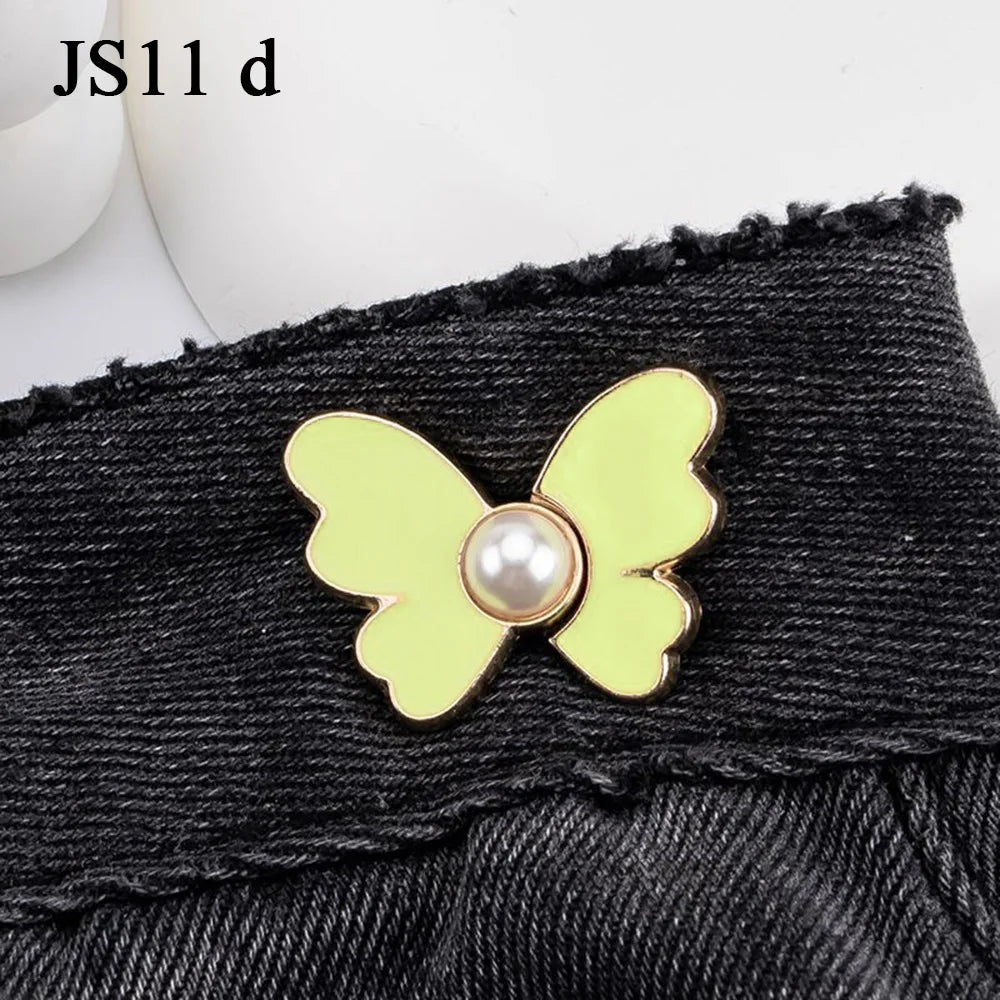 Gold pearl butterfly buttons attached to a black denim fabric.