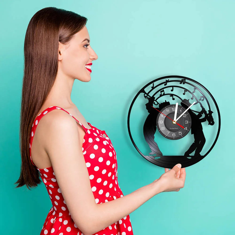 A woman holds a black vintage vinyl record wall clock with a silhouette of a horse and a clock face against a teal background