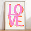 Canvas wall art featuring the word LOVE in bright pink and orange gradient lettering.