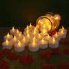 A collection of glowing white LED tealight candles arranged on a green surface with red petals.