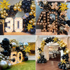 A black and gold confetti balloon garland arch display for a celebration.