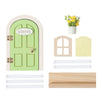 A miniature wooden fairy elf door decoration in light green with a welcome sign and tooth boxes.