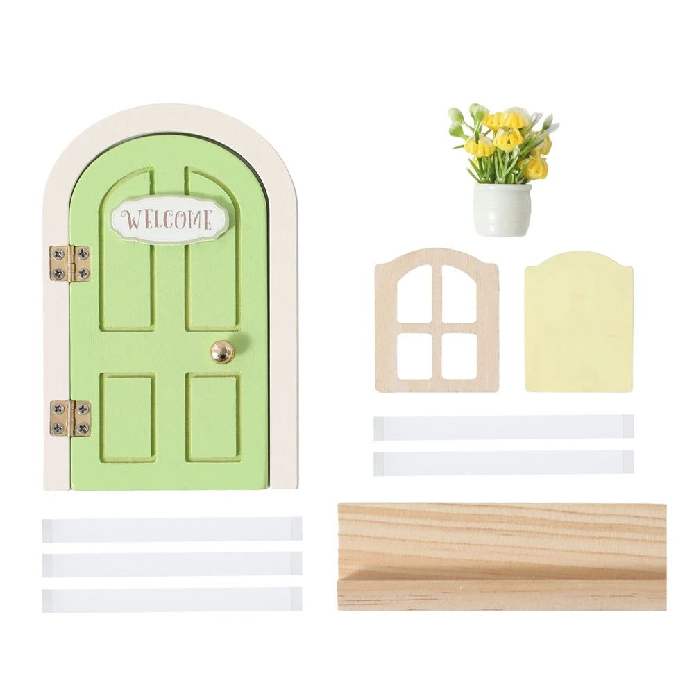 A miniature wooden fairy elf door decoration in light green with a welcome sign and tooth boxes.