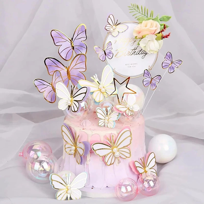 A pink tiered cake decorated with butterfly toppers and floral accents on a white background.
