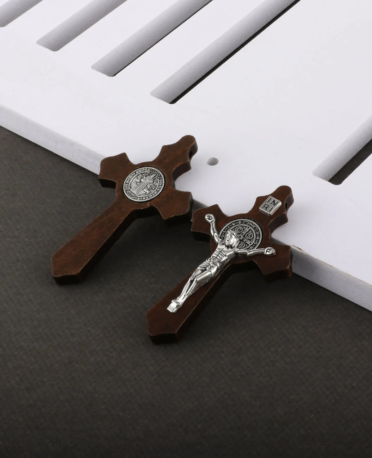 A set of wooden crucifix pendants featuring a figure of Jesus Christ and the inscription INRI.