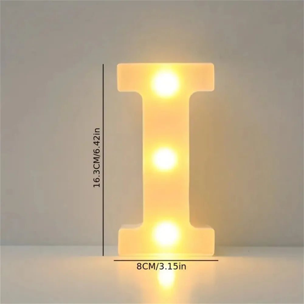 A glowing yellow LED letter light shaped like the letter I, used for room or party decor.