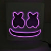 A glowing neon pink LED face mask with a smiling expression and flashing light modes.
