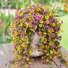 A vibrant arrangement of purple, yellow, and pink faux silk flowers used for outdoor decoration.