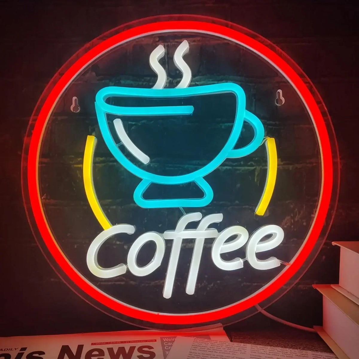 A neon sign displaying the word Coffee in white light on a dark background.