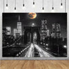 A dramatic night cityscape featuring tall buildings and a large moon in the sky.