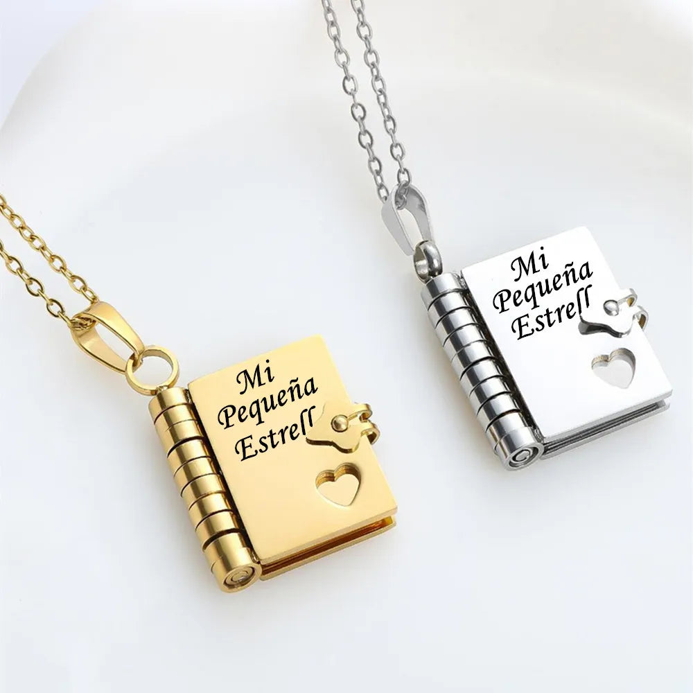 A gold-colored openable book pendant necklace with an engraved message and a silver-colored version.