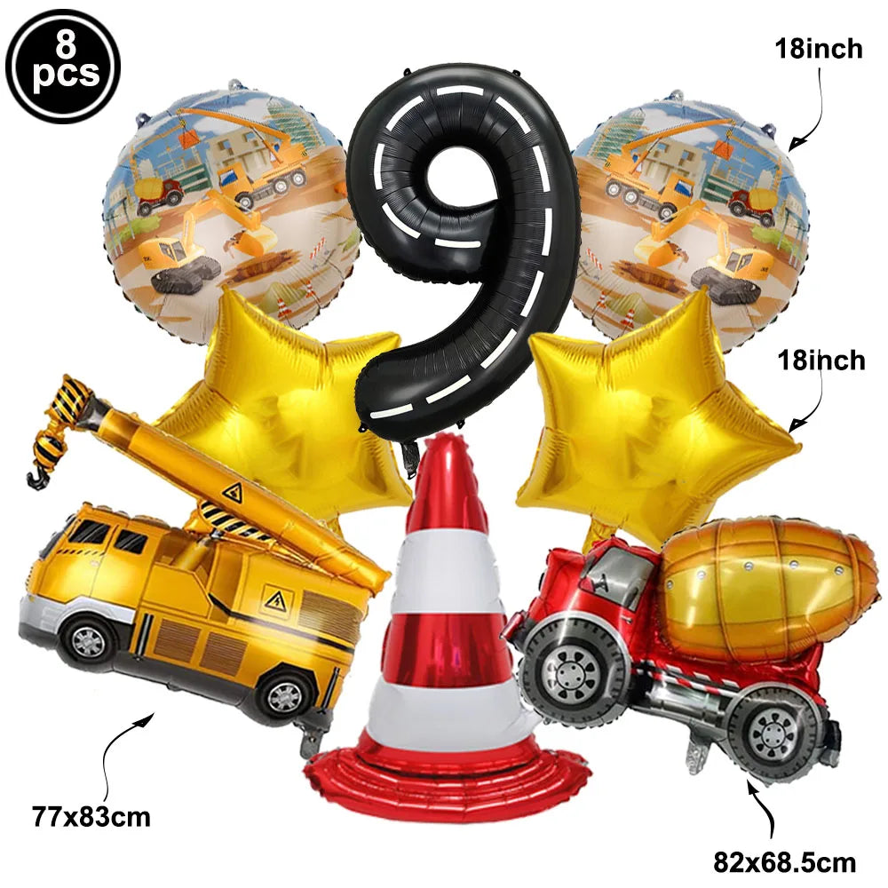 A set of nine gold and black foil balloons shaped like the number 9 and a construction truck, along with a red and white traf