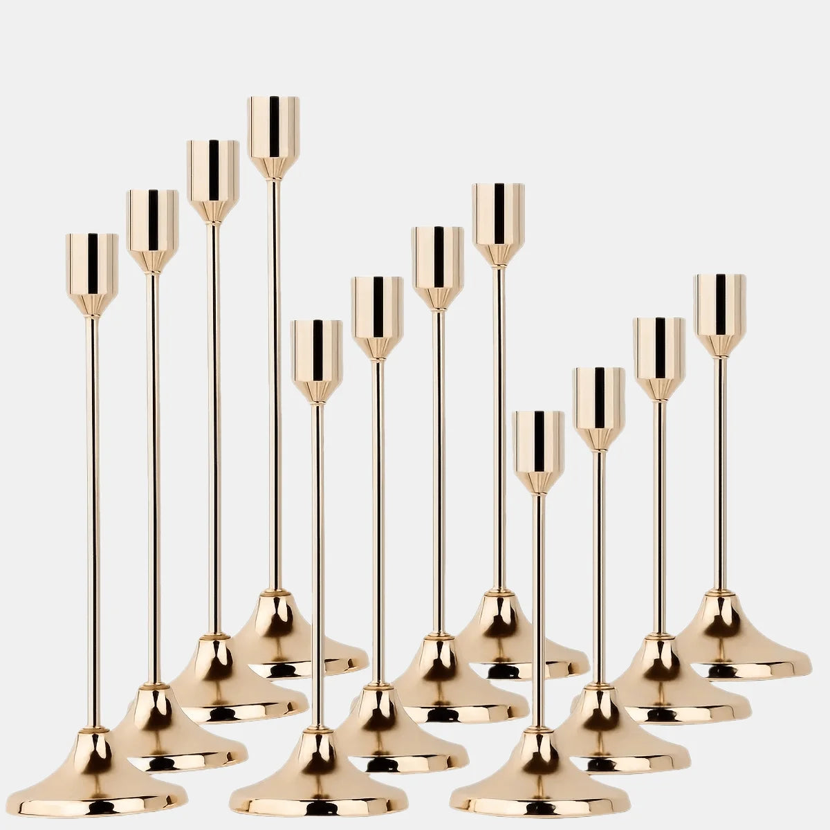 A set of twelve elegant gold metal candle holders with slender stems and flared bases.
