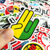A hand holds a yellow and green JDM style vinyl decal sticker on a white background.